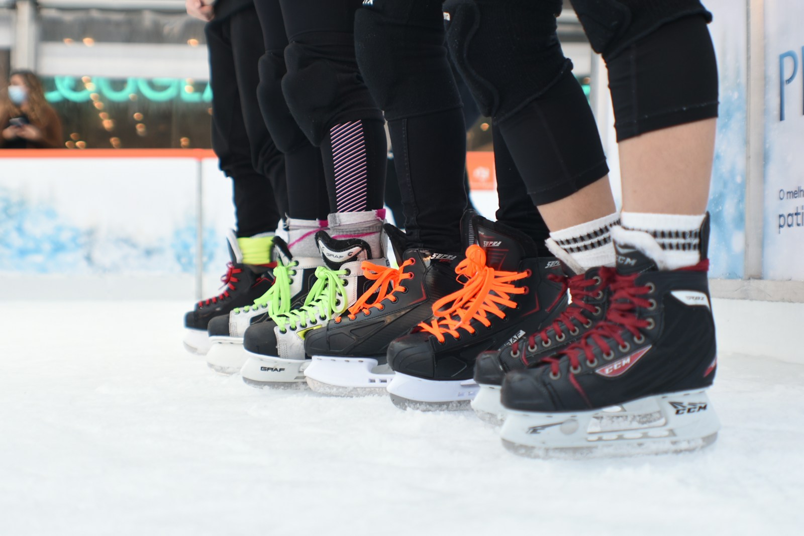 a group of people standing on top of a ice rink